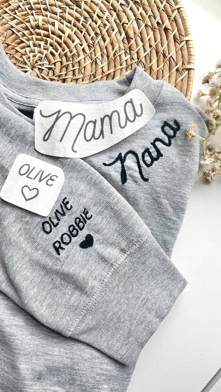 Grey sweatshirt with Nana and grandchildren's names embroidered on the chest and sleeve.