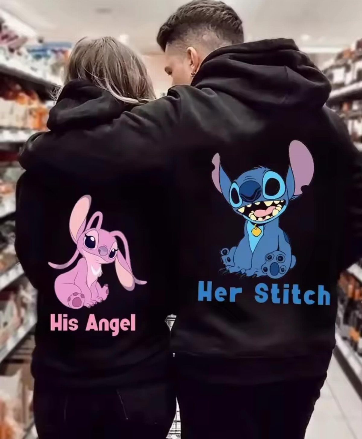 Couple wearing matching black hoodies with Stitch and Angel characters on the back