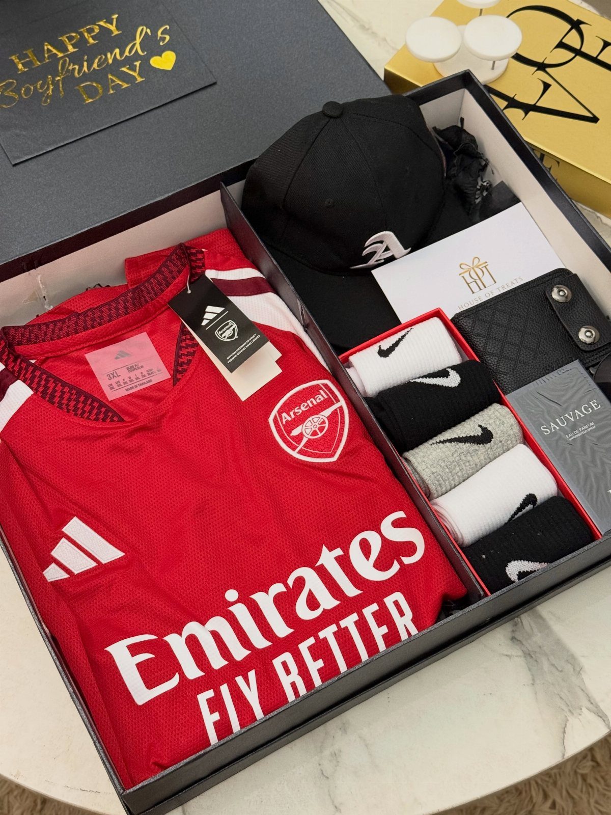 Arsenal soccer jersey, black cap, and Nike socks in a gift box