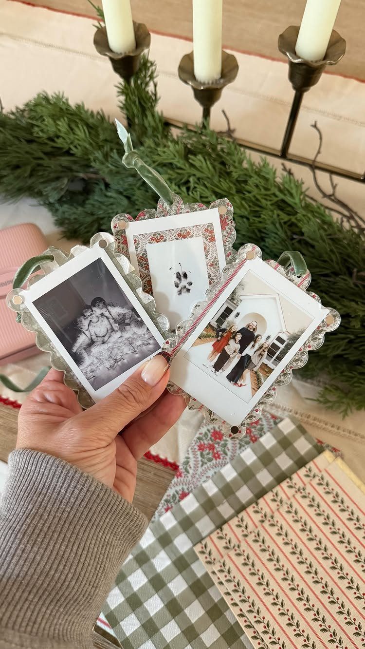 Three-paneled photo ornament with scalloped edges held against a festive holiday background.
