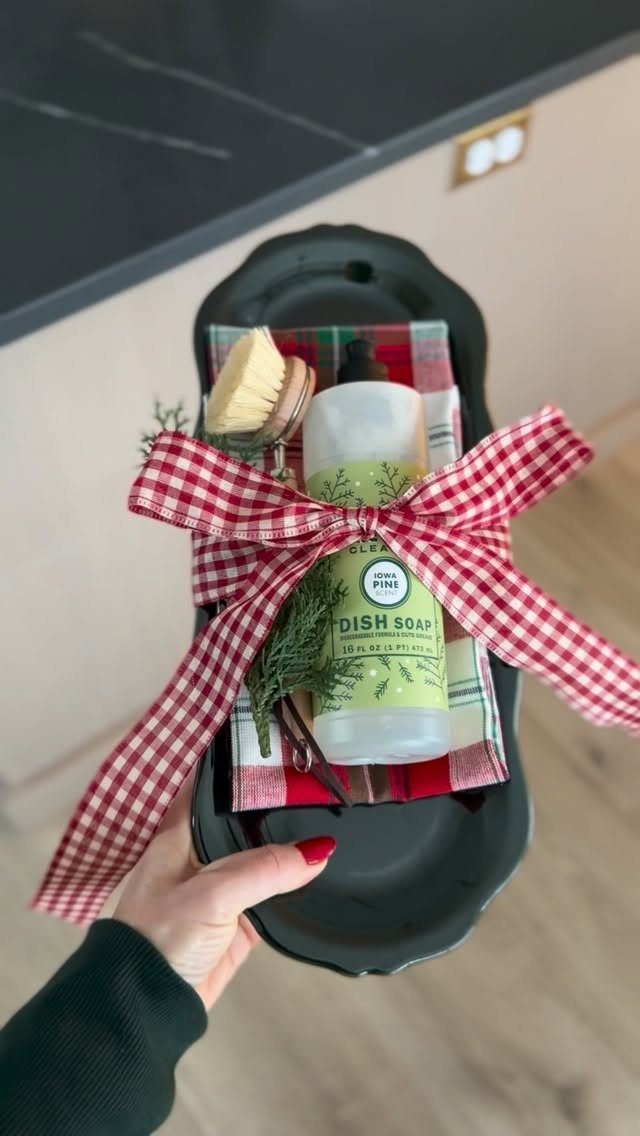 Dish soap and scrub brush in a black tray with a gingham bow