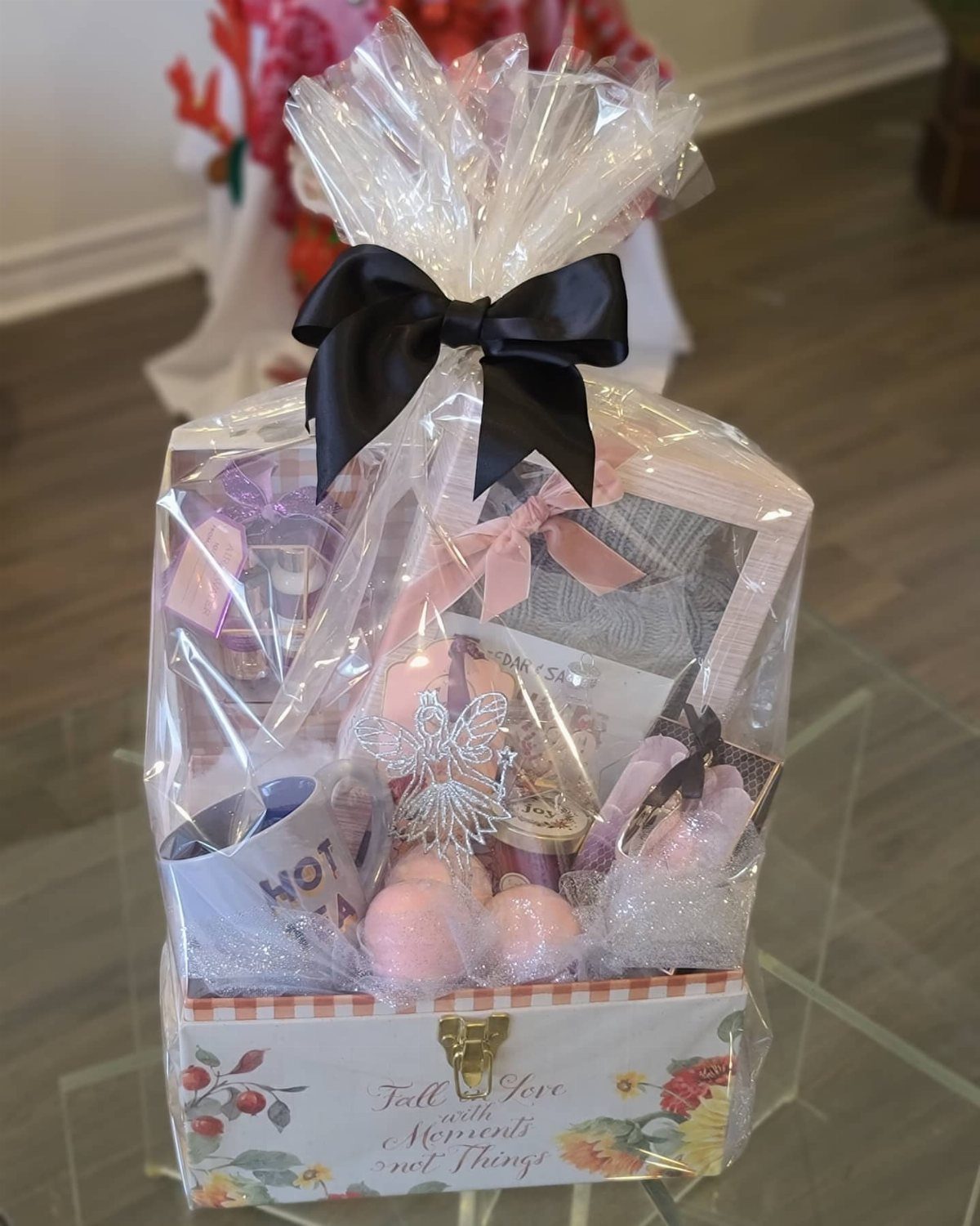 Gift basket with bath bombs and a mug wrapped in clear cellophane.