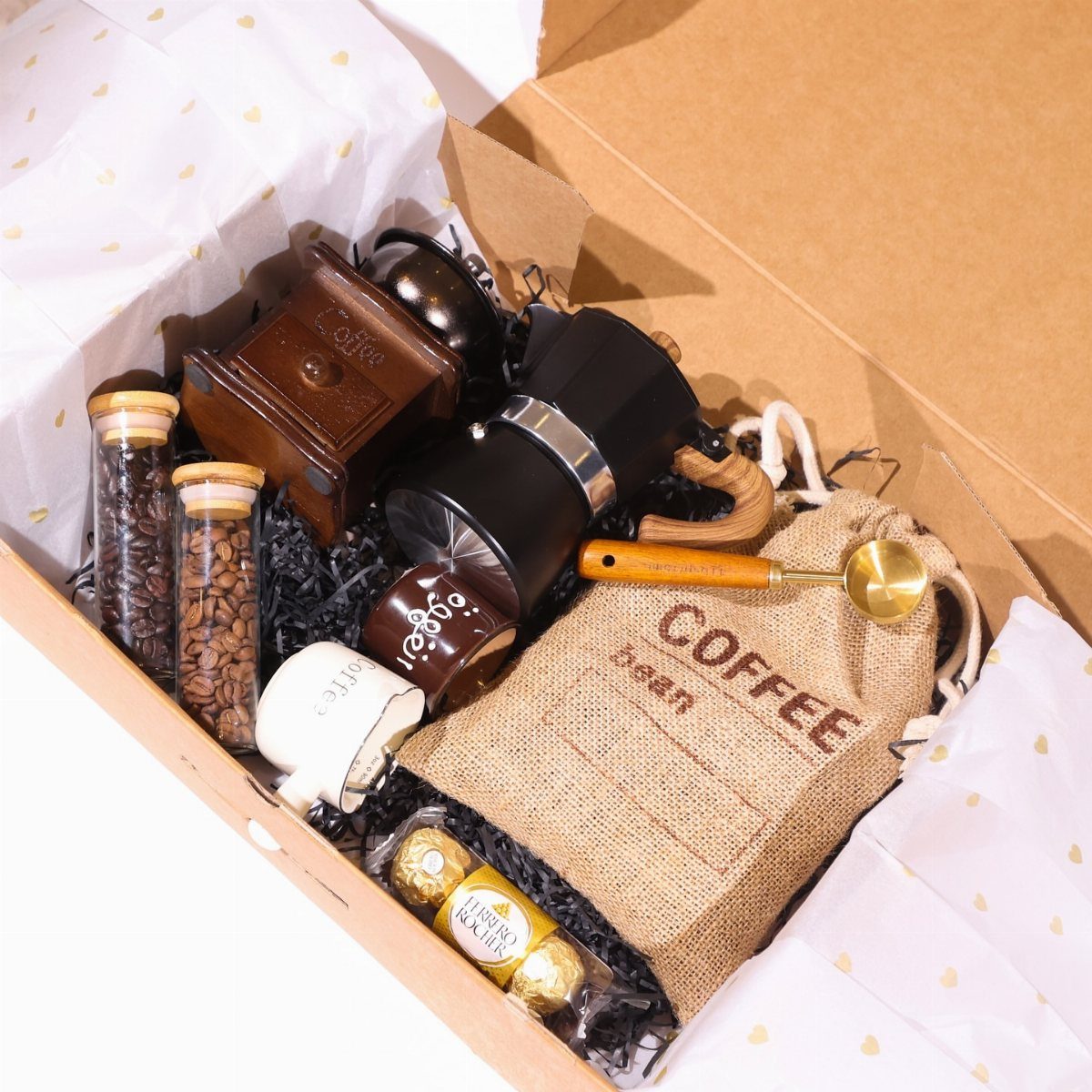 Coffee lover gift box with grinder, French press, beans, and a burlap bag.