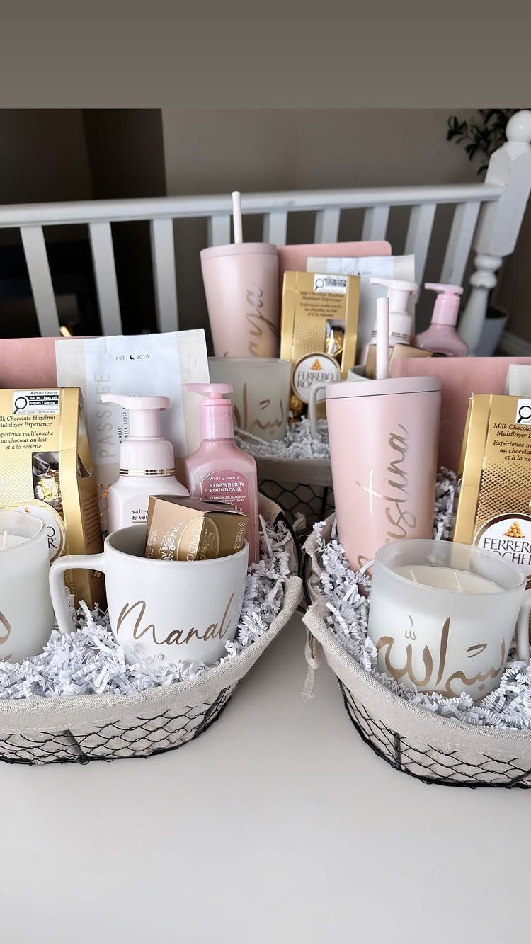 Three gift baskets filled with pink tumblers, personalized mugs, and beauty products.