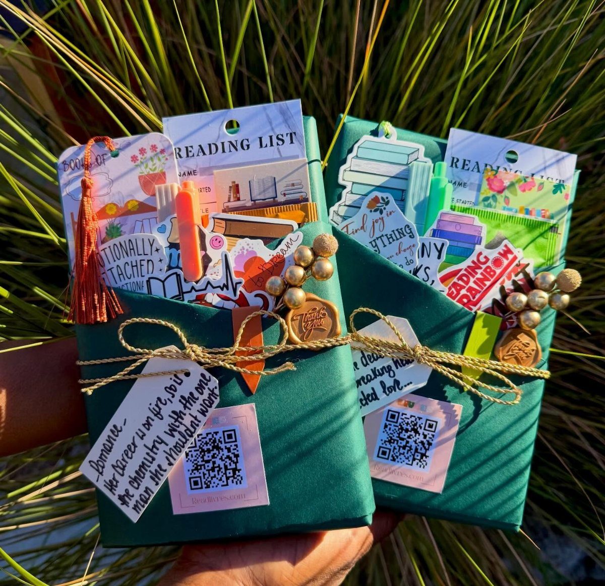 Two green stationery gift sets with reading lists and stickers tied with twine.