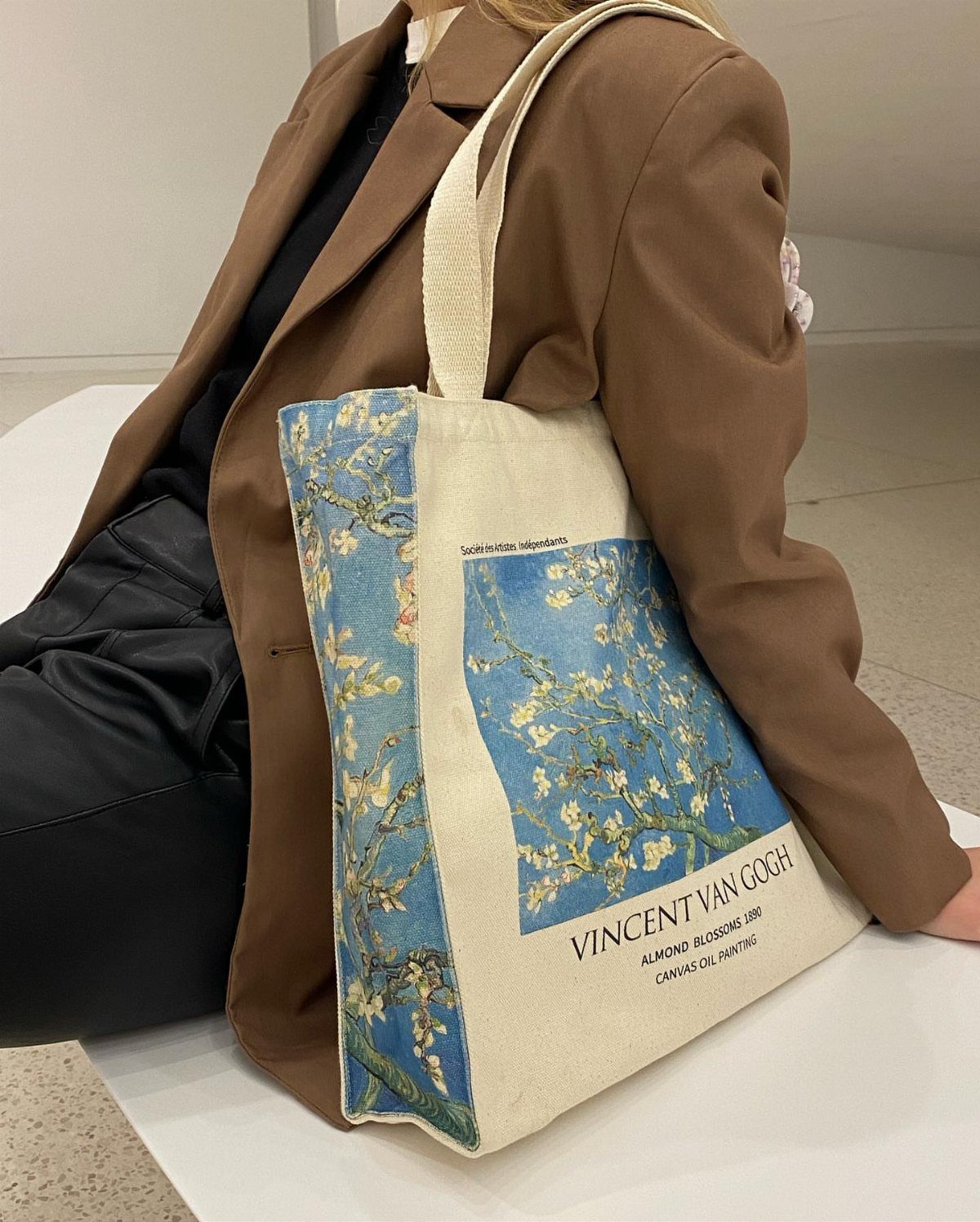 Canvas tote bag with Van Gogh almond blossom art held by person in blazer