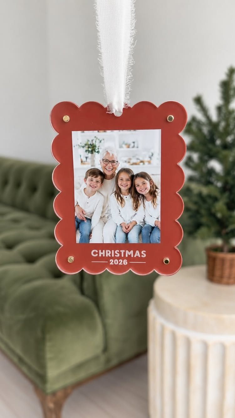 Red scalloped Christmas ornament featuring a family photo and the year 2026.