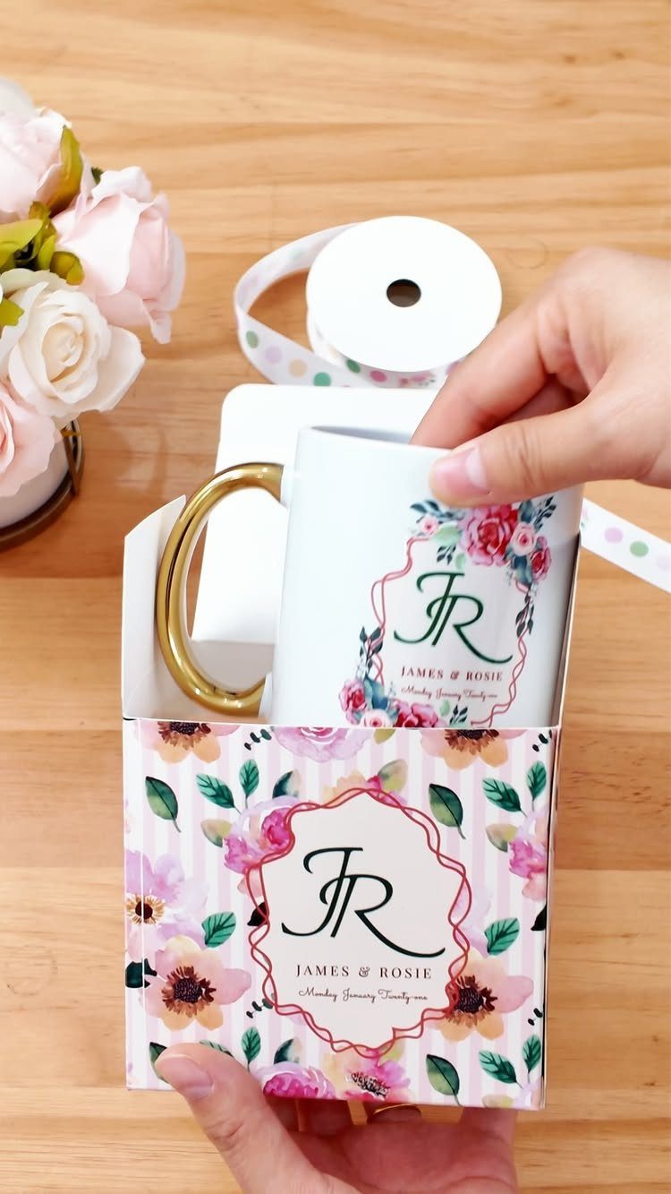 Personalized white coffee mug with gold handle and floral monogram in gift box