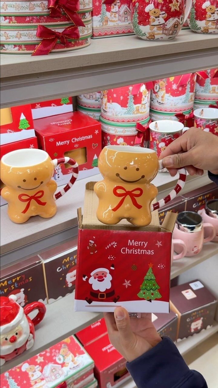 Gingerbread man shaped ceramic mug with candy cane handle in a red gift box
