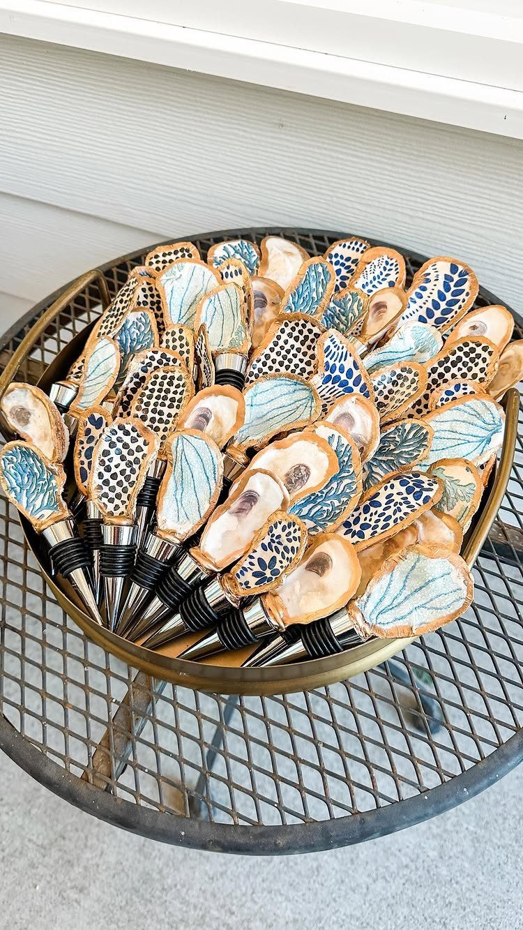 Decorative cocktail picks with patterned ceramic handles in a gold metal bowl