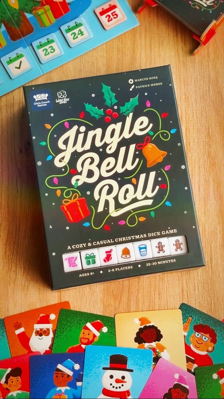 Jingle Bell Roll board game box with colorful character cards on wooden table