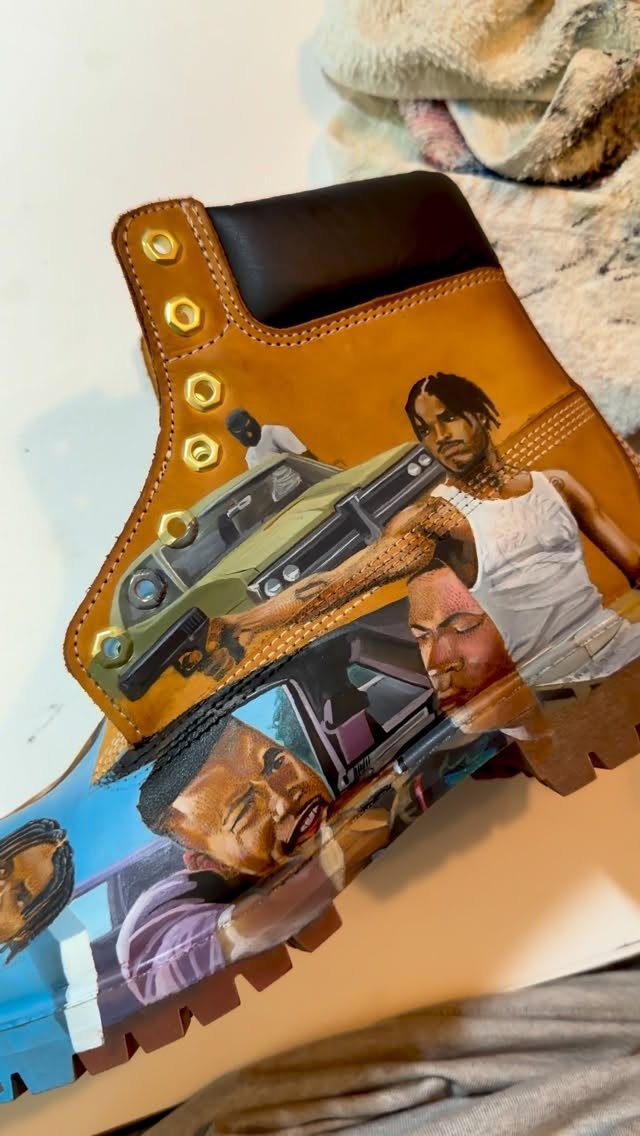 Custom airbrushed leather boot with detailed portraits of men and cars.