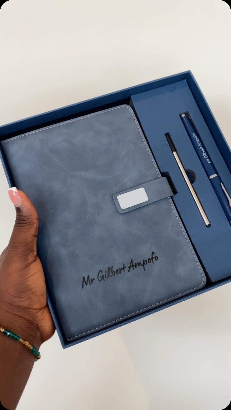 Blue personalized notebook and pens in a matching gift box held by hand