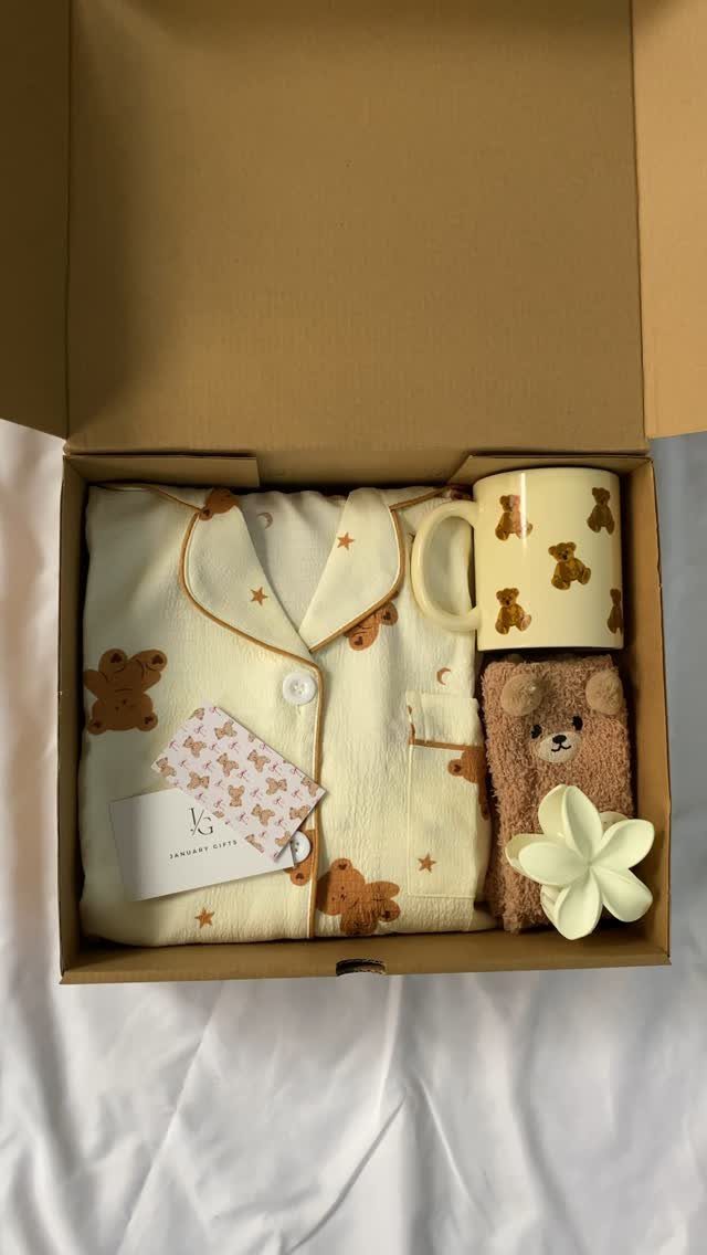 Gift box with bear-print pajamas, a matching mug, and a small teddy bear.