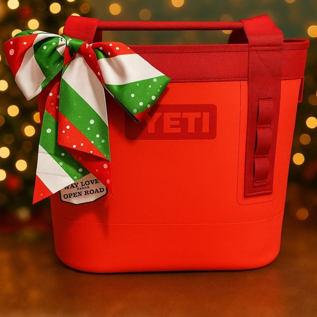Red YETI cooler bag with a festive Christmas bow and blurred lights background