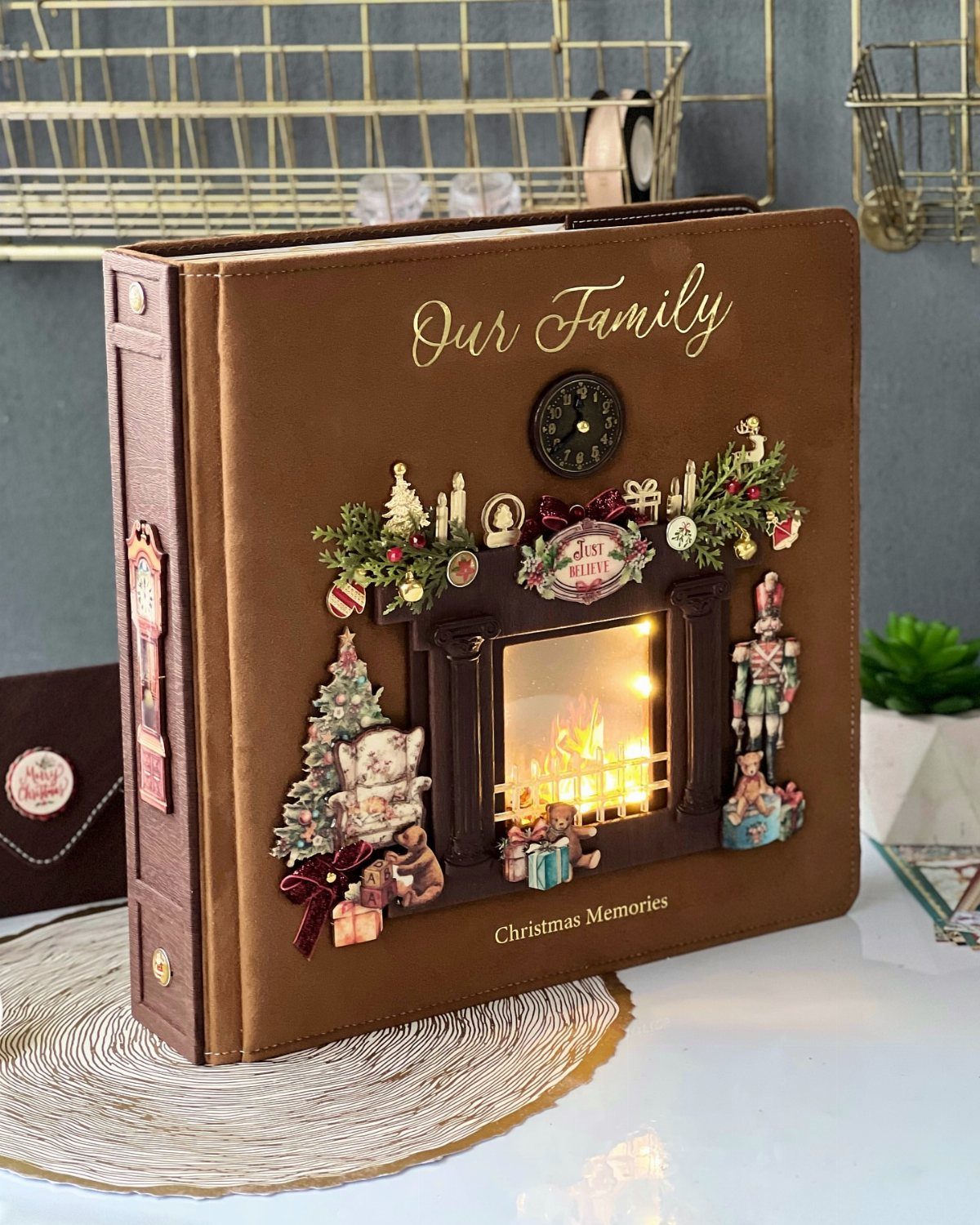 Brown leather family photo book with a glowing 3D Christmas fireplace cover design.