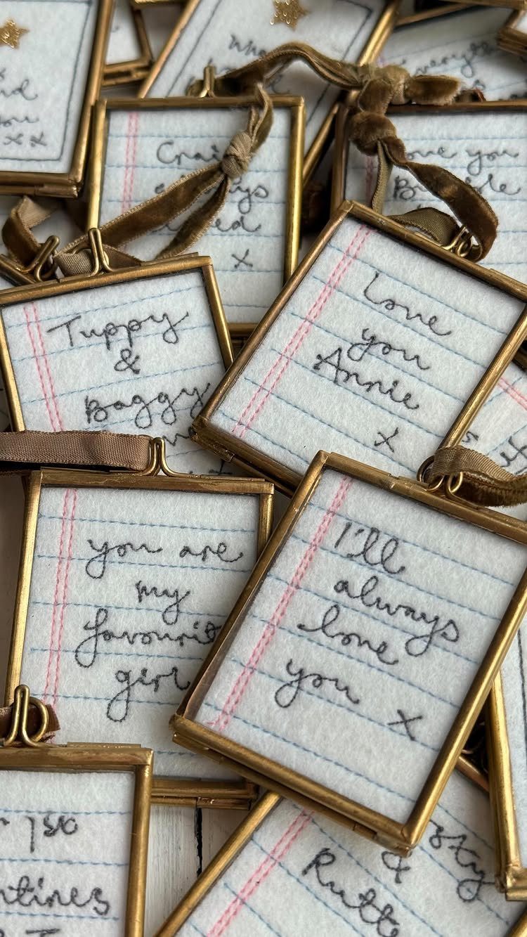 Handwritten notes in gold frames used as sentimental ornaments with brown ribbons.
