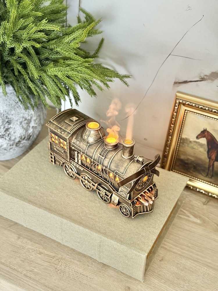 Bronze steam locomotive oil lamp with flickering flames on a beige box