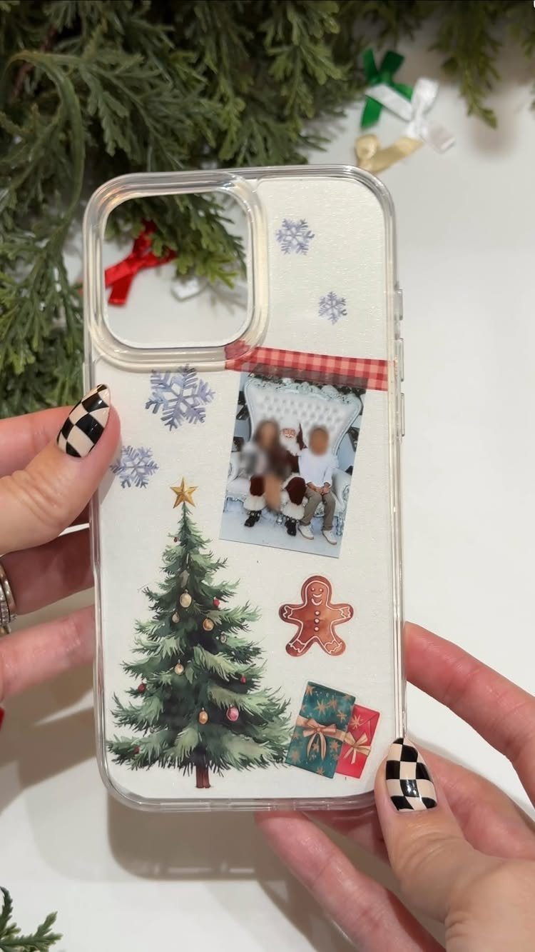 Decorated clear phone case with Christmas tree and photo held by hands
