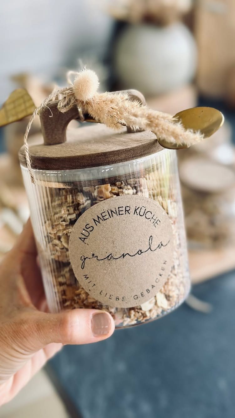 Glass jar filled with granola, featuring a brown label and twine bow.