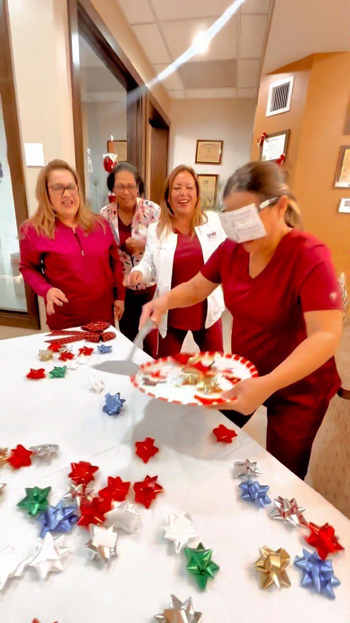 Medical staff playing a game with colorful gift bows on a white table.