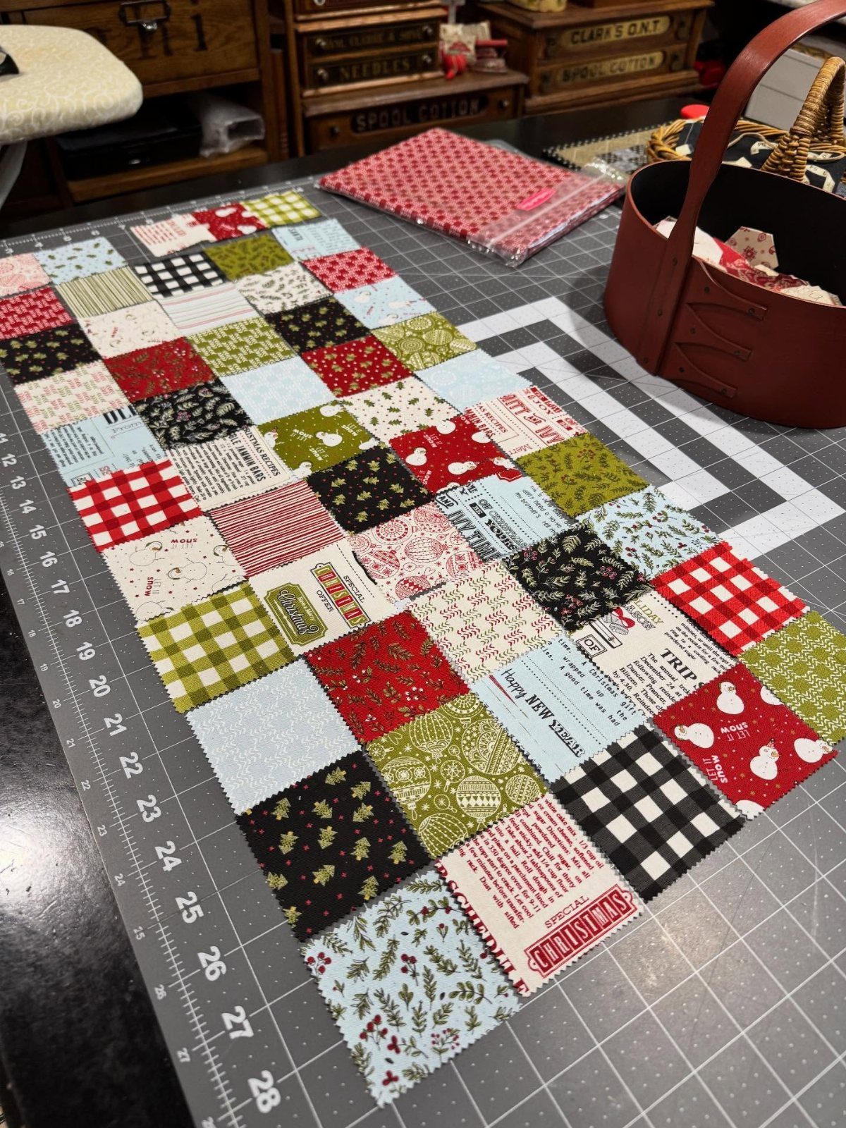 Quilted table runner made from colorful fabric scrap squares on a cutting mat.