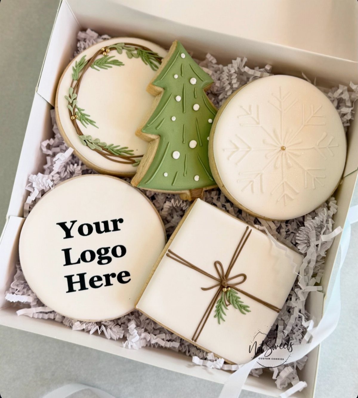 Decorated holiday sugar cookies in a white gift box with logo placeholder.