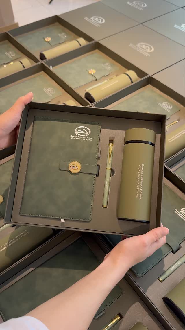 Olive green corporate gift set with notebook, pen, and thermos in a box