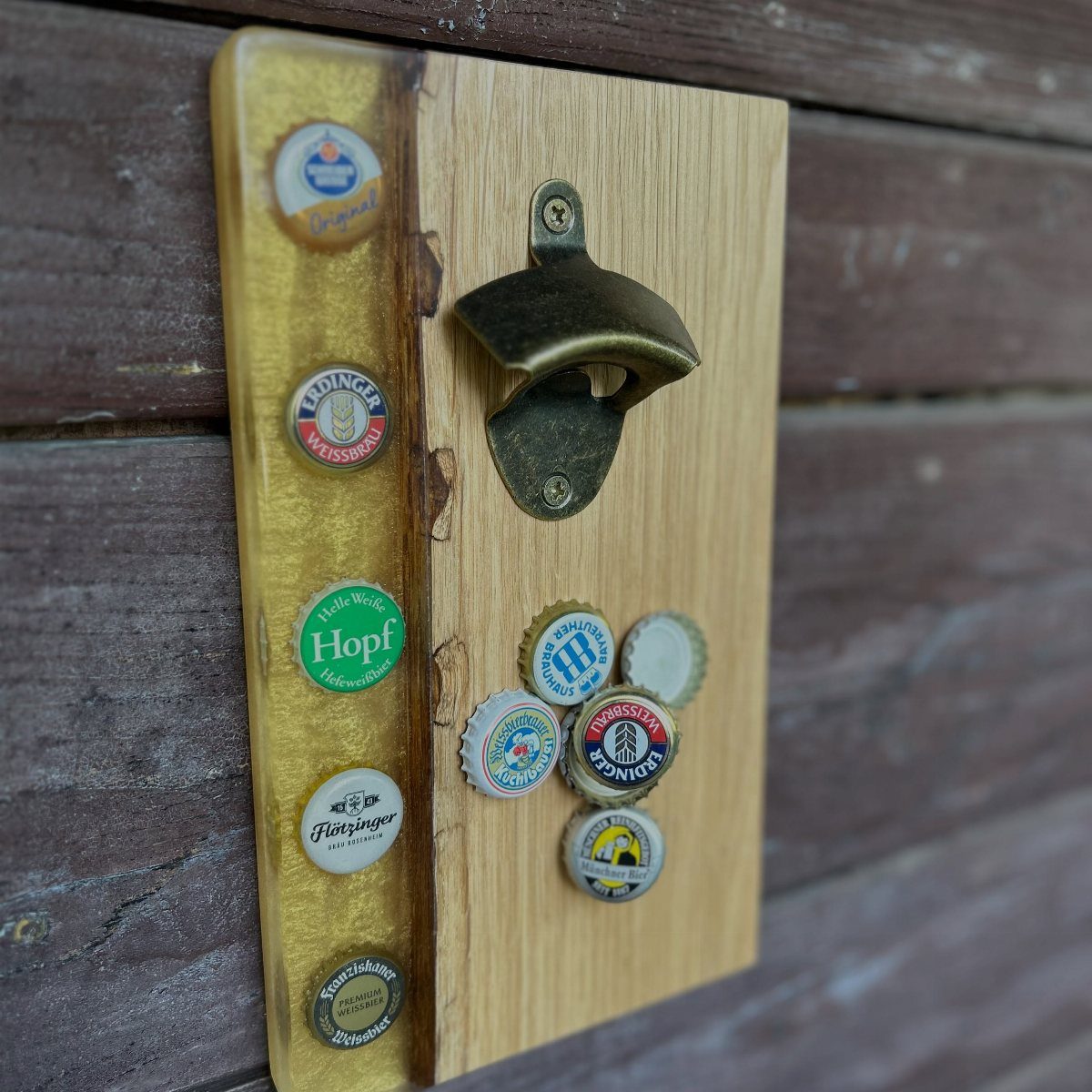 Wooden wall-mounted bottle opener with embedded and scattered colorful beer bottle caps.