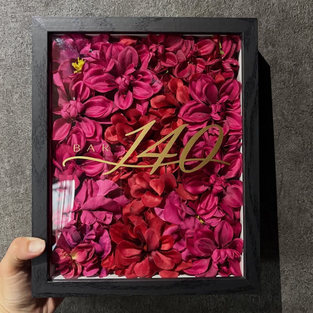 Framed arrangement of deep red flowers with gold 40th birthday script overlay.