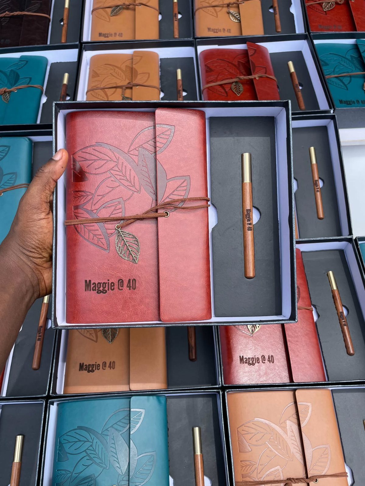 Red personalized leather journal and matching pen in a black gift box