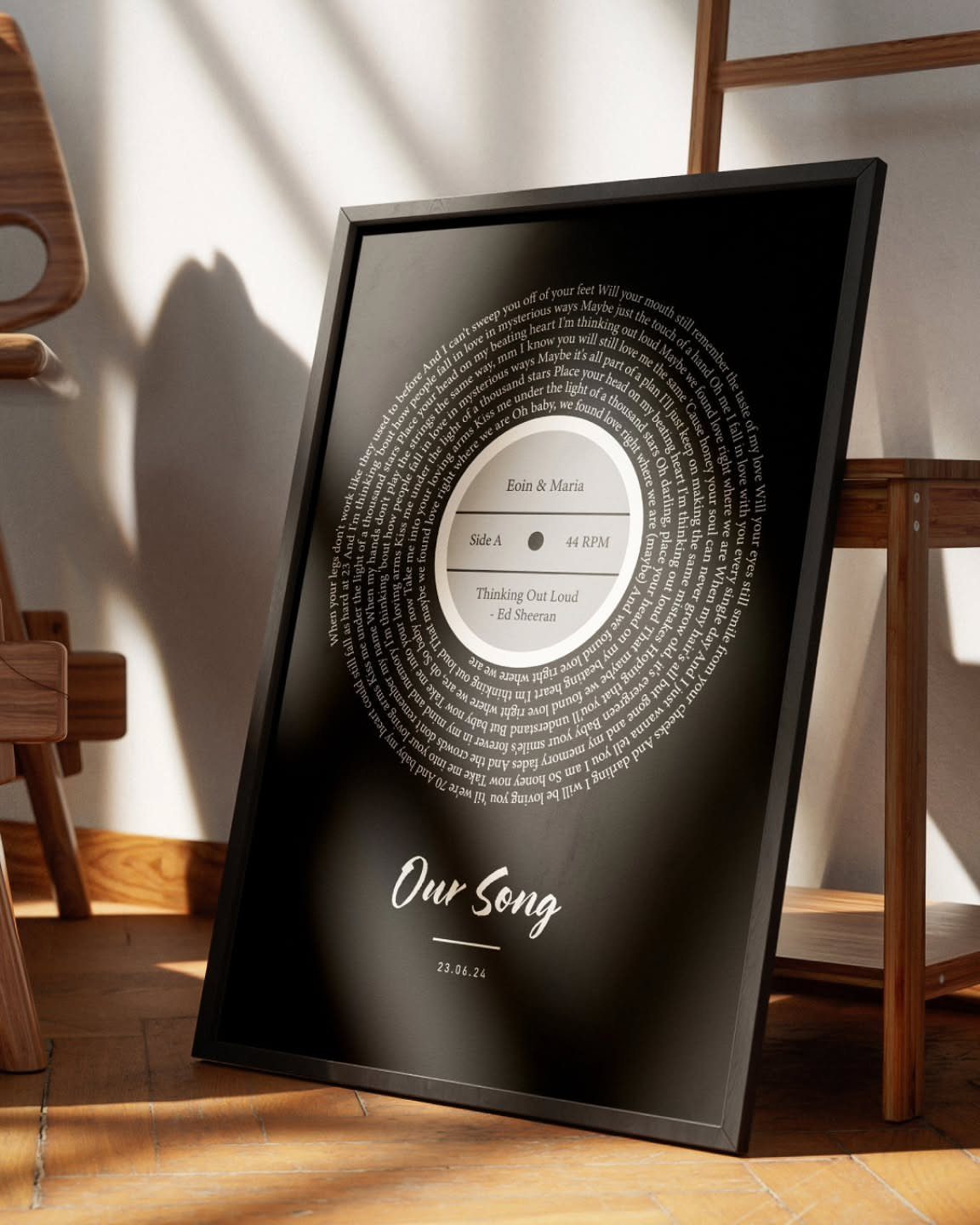 Framed music print with a vinyl record design and spiraling text on black background