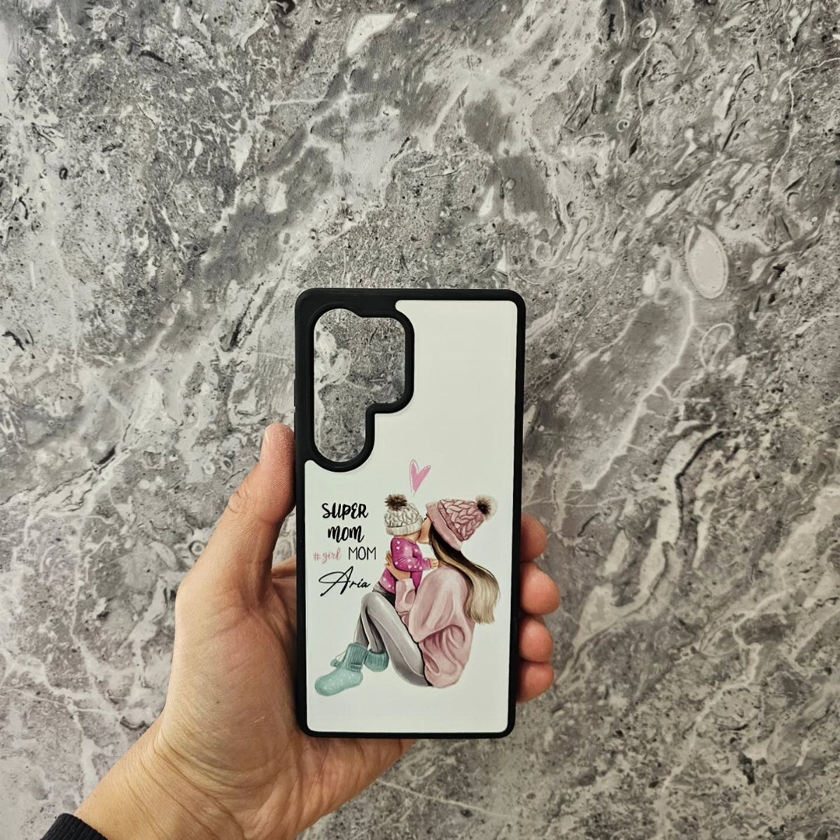 White phone case with an illustration of a mother and daughter hugging.