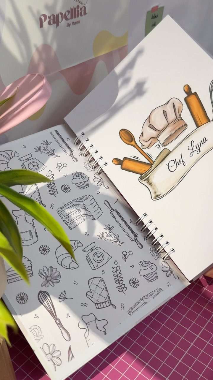 Spiral-bound personalized recipe book with chef illustrations and the name Chef Lyna.