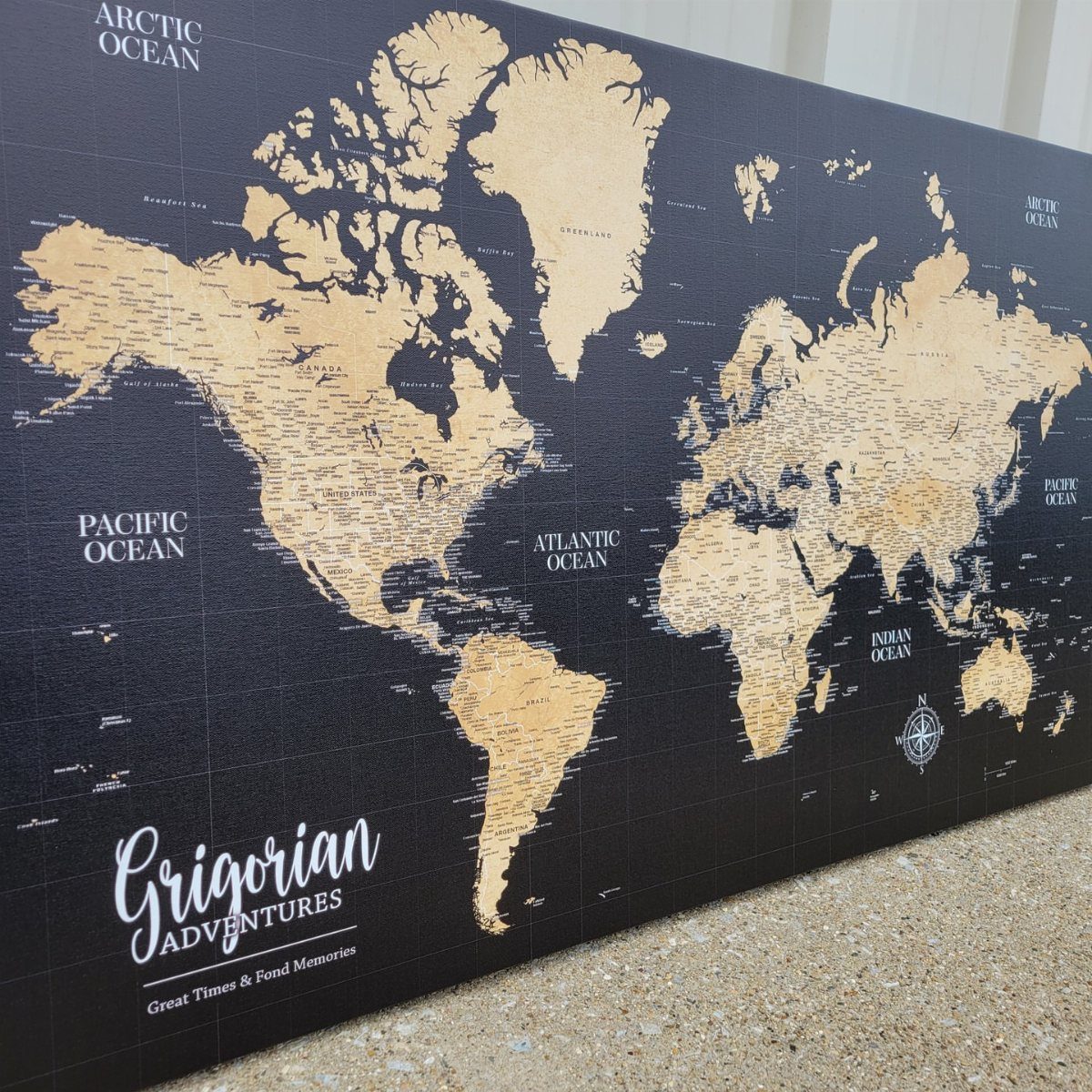 Gold world map on black background with personalized Grigorian Adventures text at bottom.