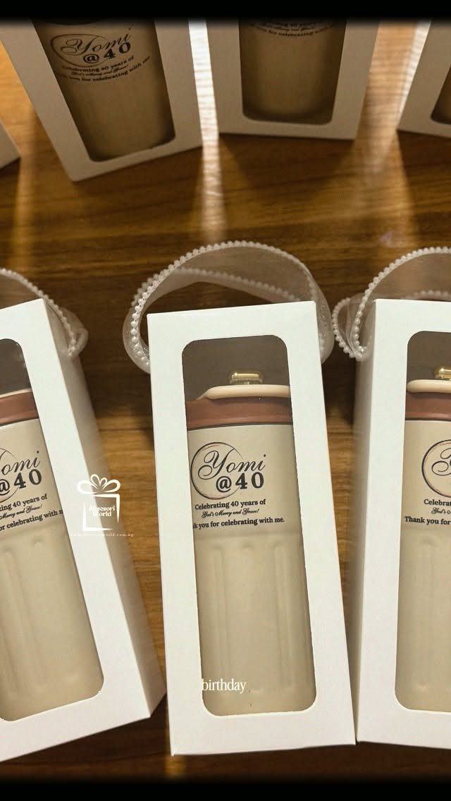 Beige personalized tumblers in white gift boxes celebrating a 40th birthday for Yomi.