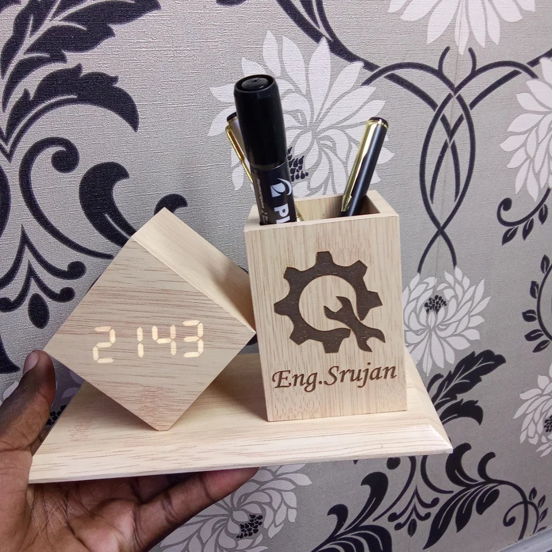 Wooden desk organizer with a digital clock and pen holder engraved with a gear.