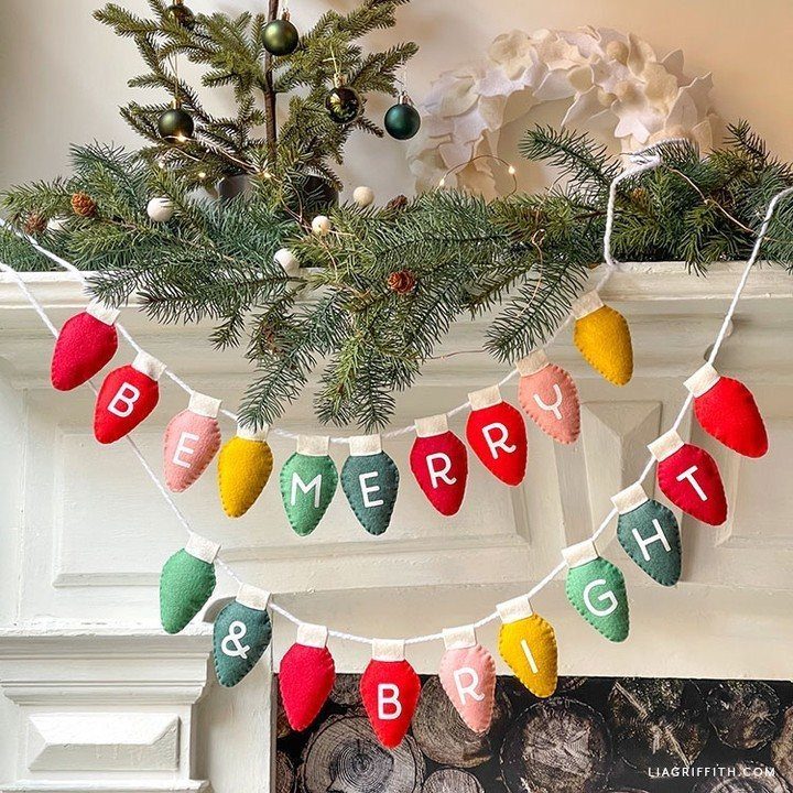 Felt Christmas light bulb garland spelling Be Merry and Bright on a mantel