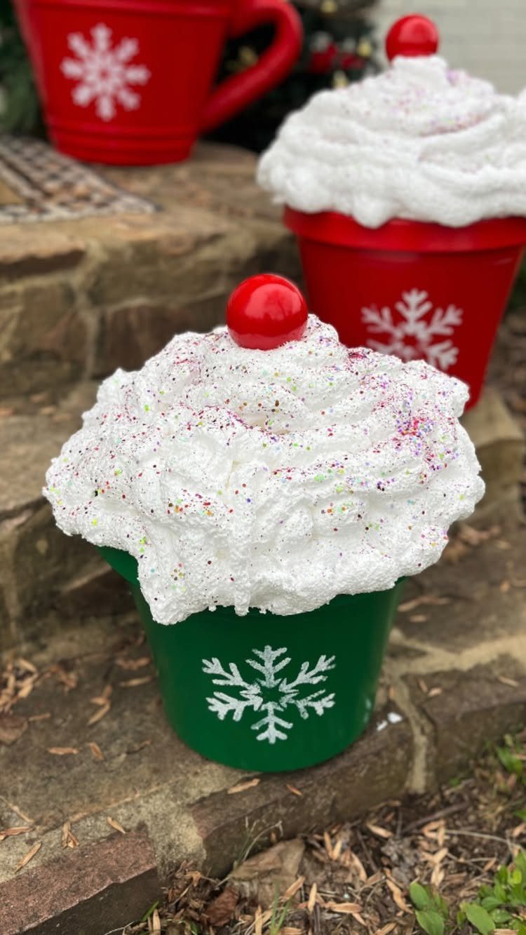 Painted green and red pots decorated as festive drinks with whipped cream tops.