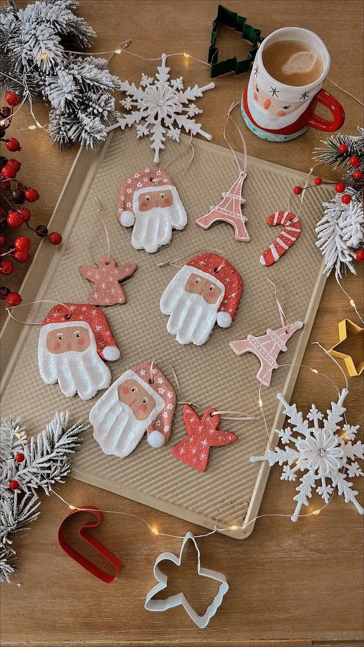 Salt dough ornaments of Santas and landmarks on a baking sheet with festive decorations.