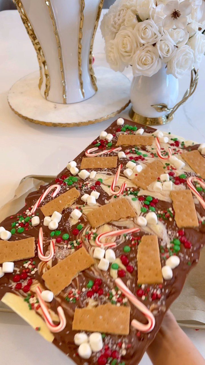 Chocolate bark topped with marshmallows, candy canes, sprinkles, and graham crackers.
