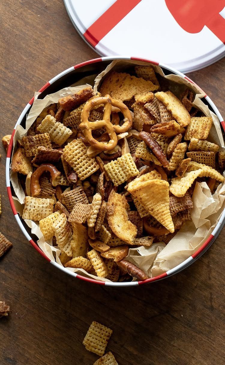 Savory Chex mix with pretzels in a red and white metal gift tin.