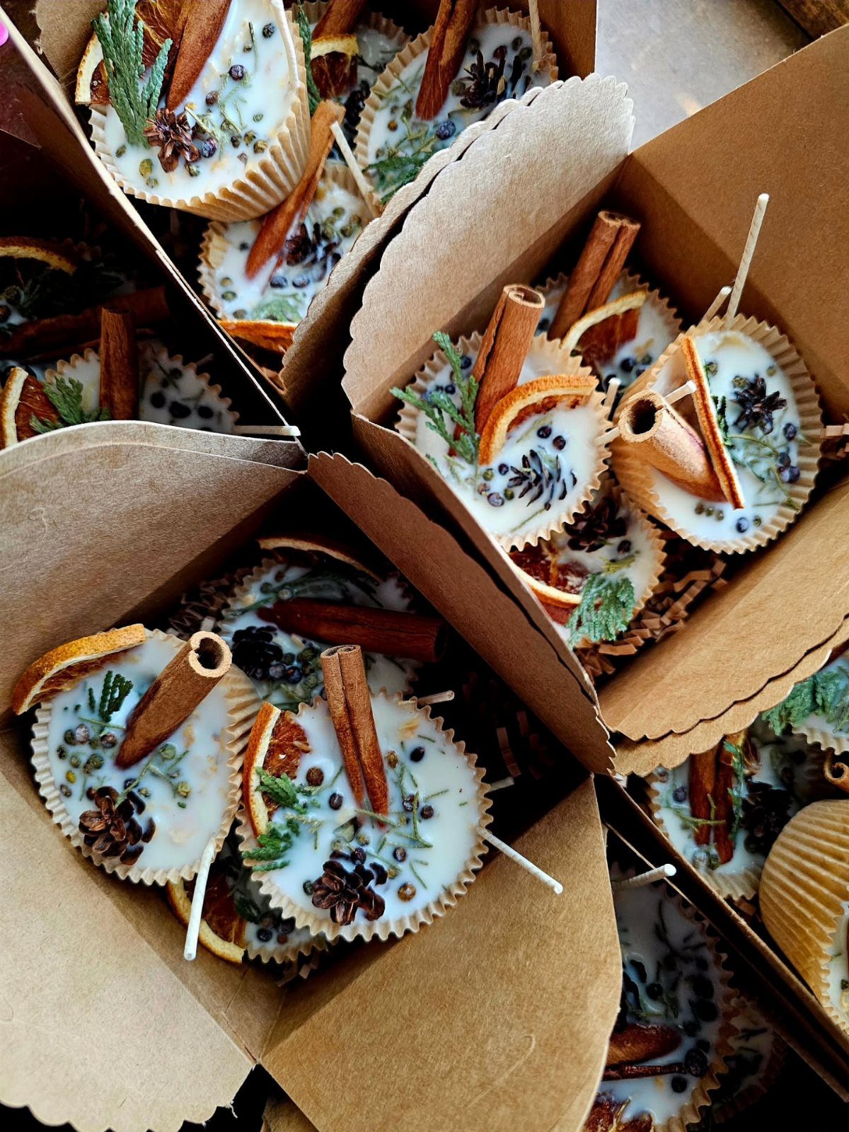 Wax fire starters with cinnamon and orange slices in brown cardboard boxes
