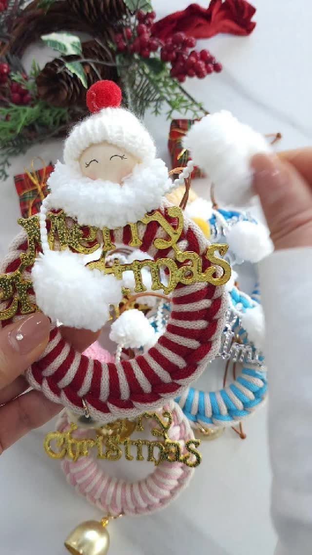 Handmade Christmas ornaments featuring a plush Santa on a red striped fabric ring.