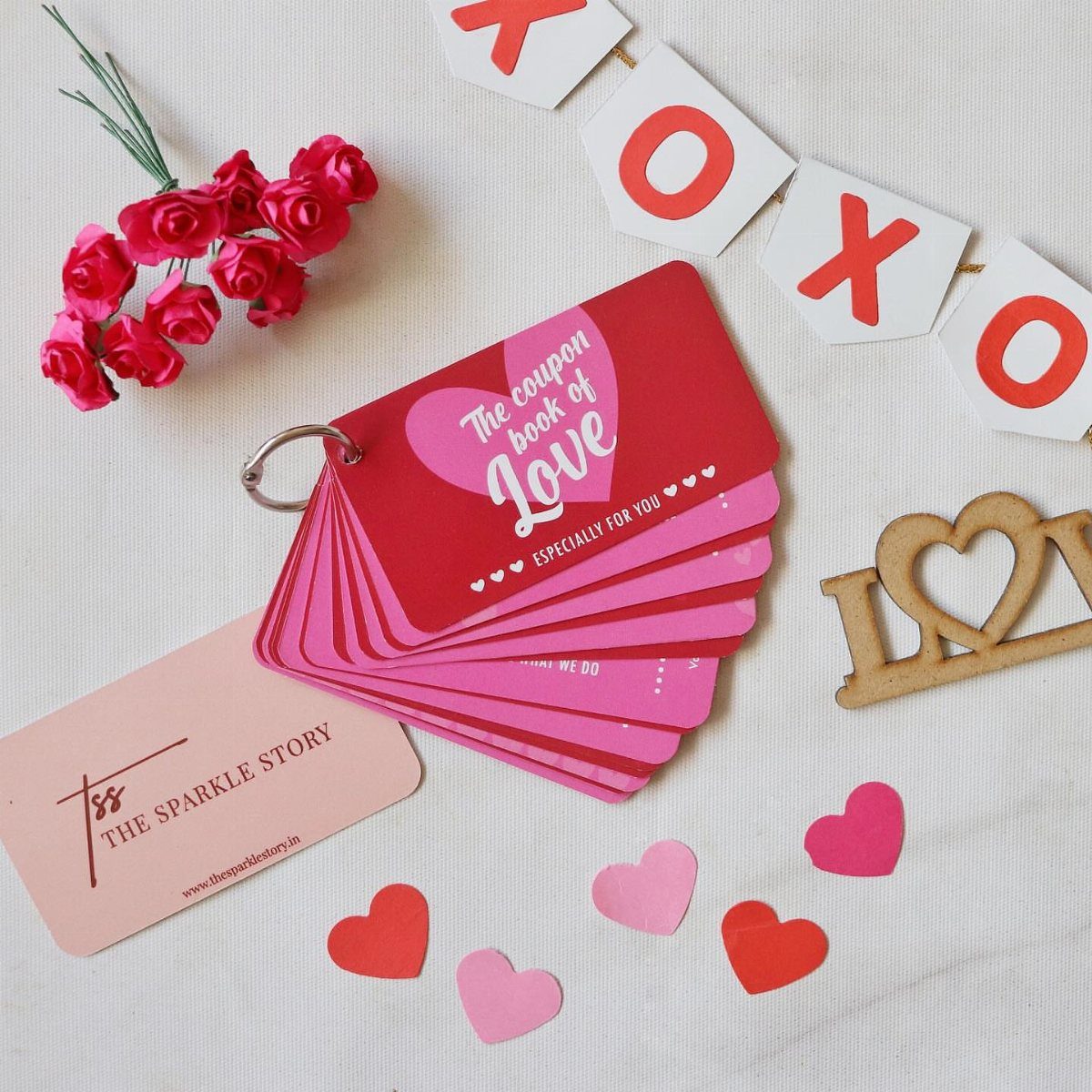 Red and pink love coupon book surrounded by roses, hearts, and XOXO banner.