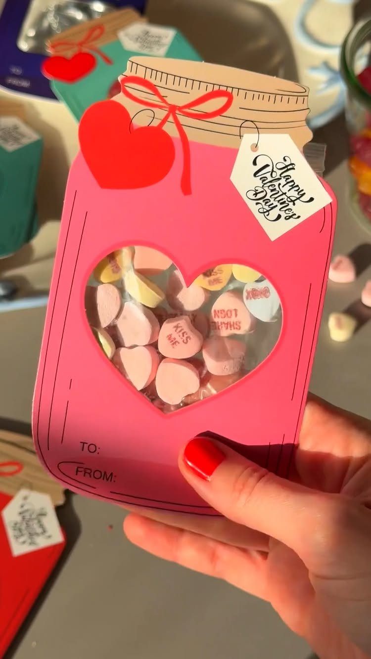 Pink mason jar shaped paper sleeve filled with heart candies for Valentine's Day