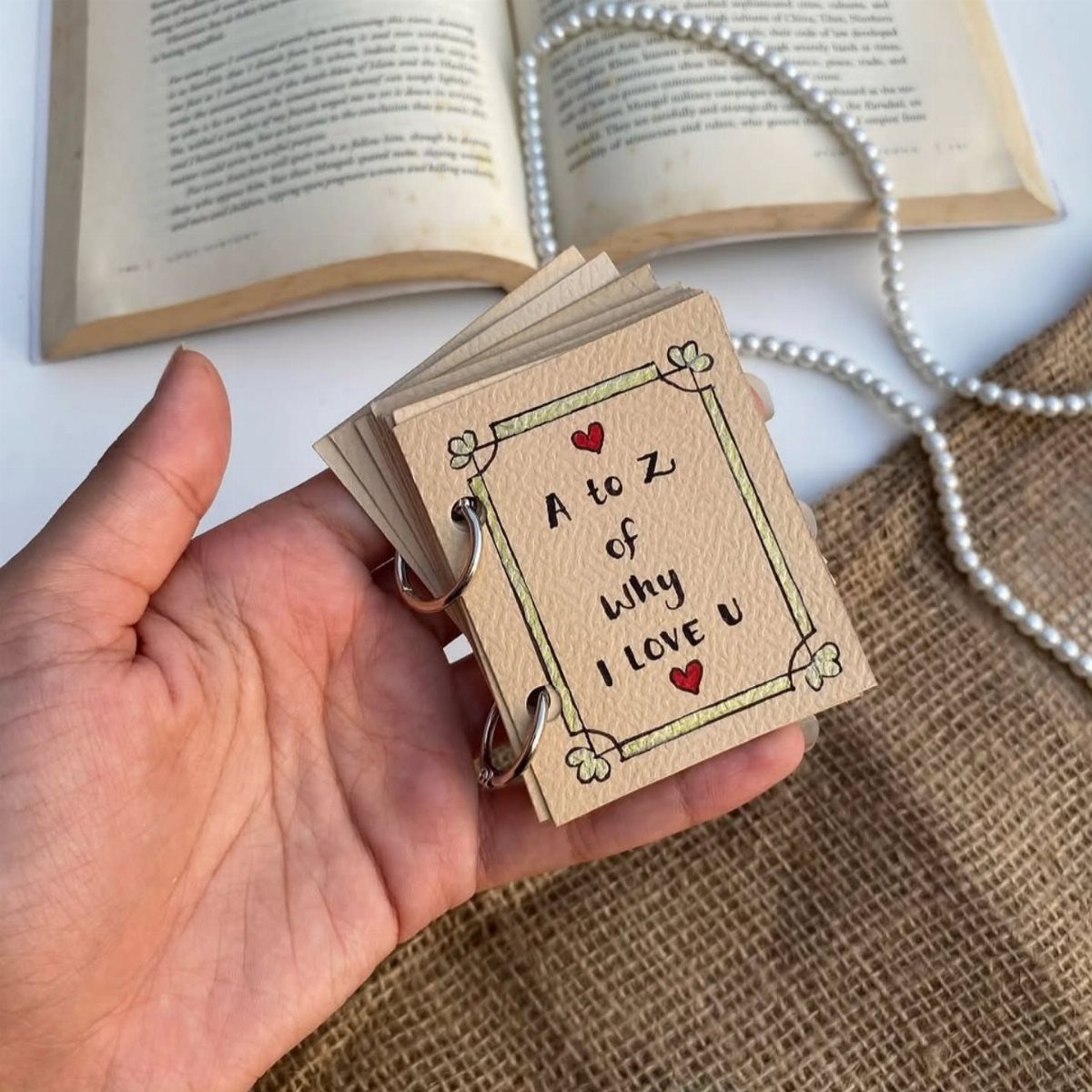 Handmade ring-bound booklet titled A to Z of Why I Love U with hearts.