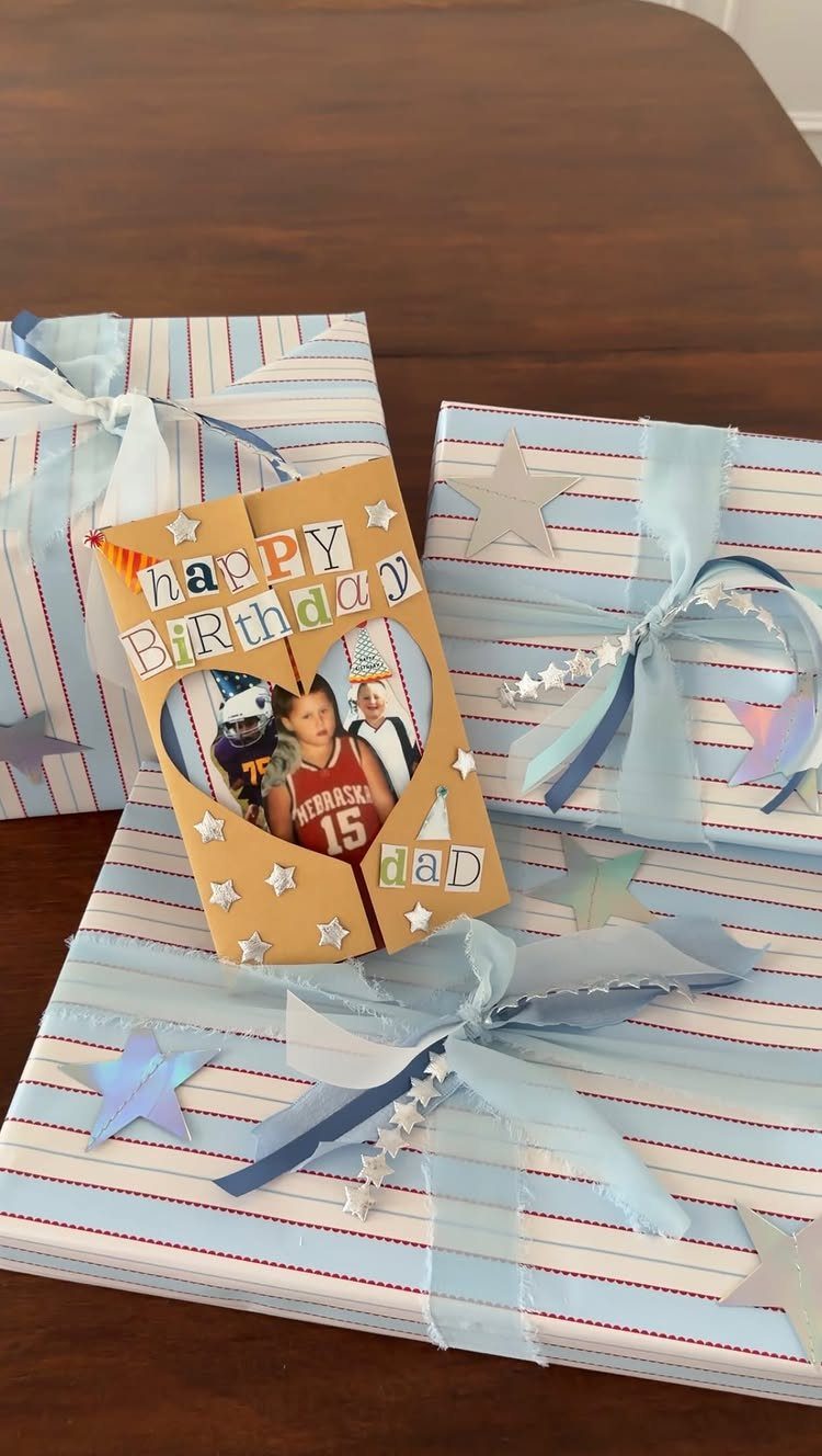 Handmade birthday card for dad with a photo resting on wrapped gifts.