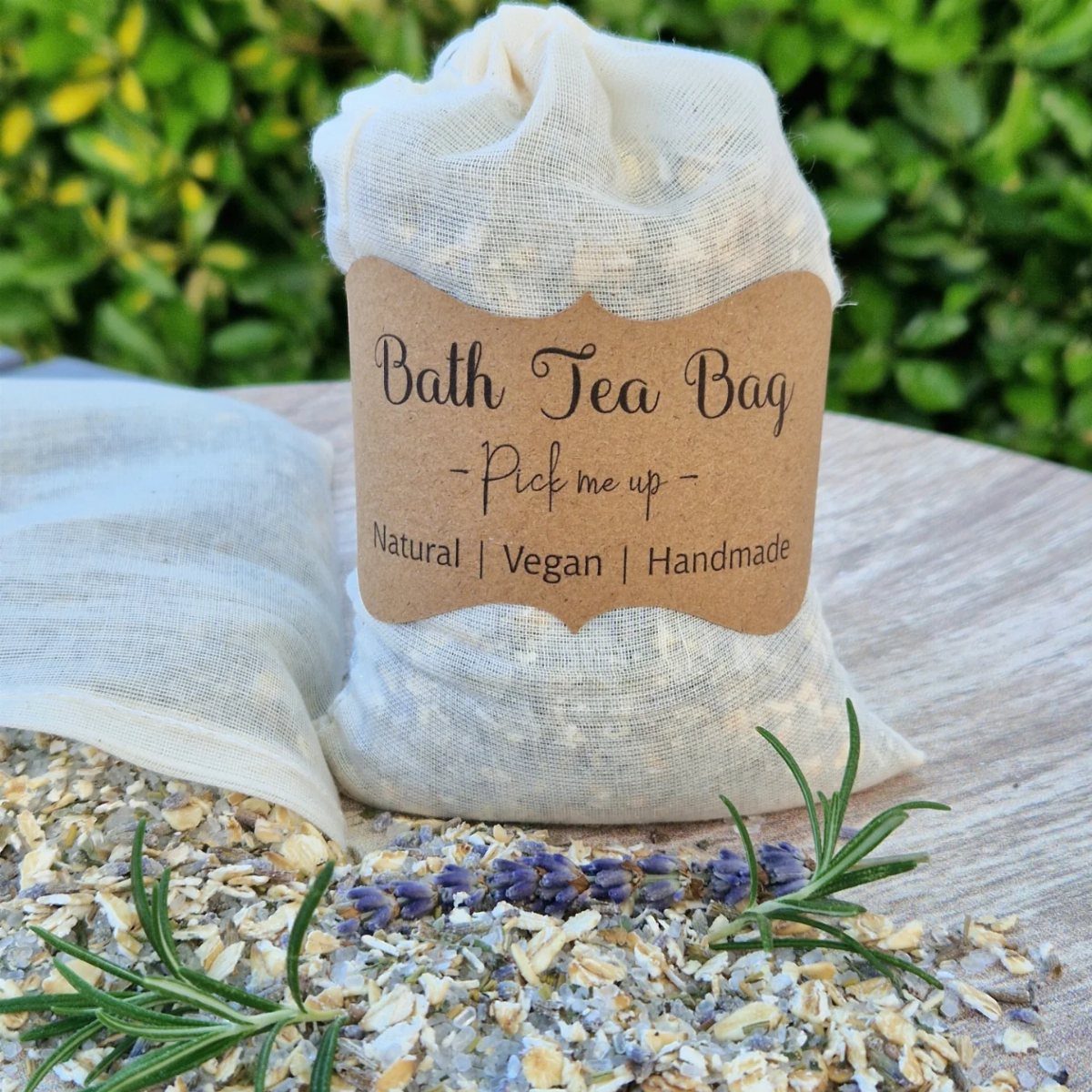 Bath tea bag in a fabric pouch with a brown label and dried herbs.