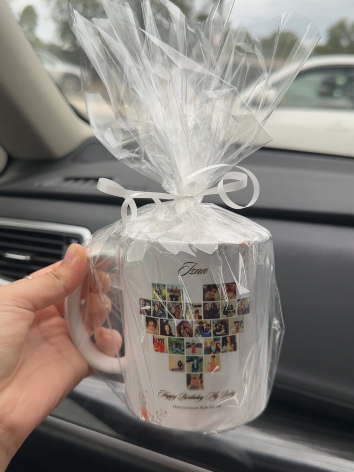Personalized white mug with heart-shaped photo collage wrapped in clear cellophane ribbon